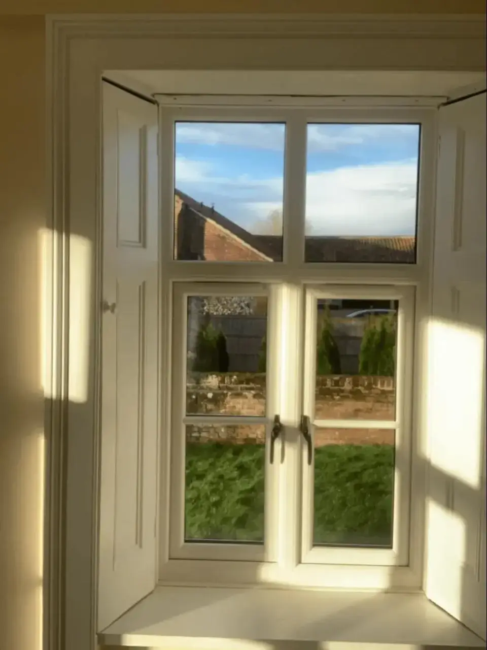 Secure uPVC French windows with energy-efficient double glazing opening out onto a garden patio in Norfolk. Installed by Norfolk Exterior Solutions